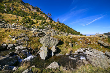 Autumn landscape with Capra river and Fagaras mountains alongside the famous Transfagarasan road in Sibiu county, Romania