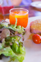 Delicious pork steak with fresh cold carrot juice for lunch or diner