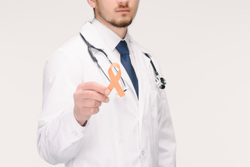 cropped shot of doctor with stethoscope showing orange ribbon isolated on white, world health day concept