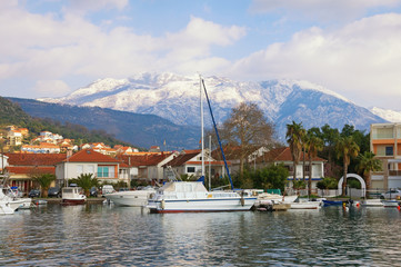 Fototapeta na wymiar Montenegro. View of Marina Kalimanj in Tivat city and snowy Lovcen mountain