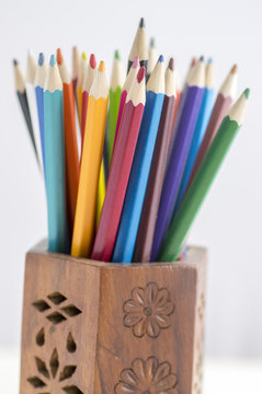 Close up of wooden colorful pencils, group of scattered crayons, isolate od white background