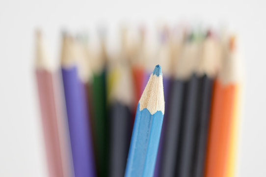 Close up of wooden colorful pencils, group of scattered crayons, isolate od white background