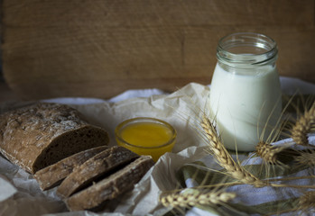  photo of dark bread with honey and milk