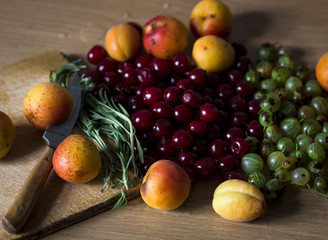  a lot of different fruits and berries on the kitchen table