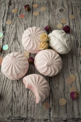  a gentle photo of a pink marshmallow on a wooden table