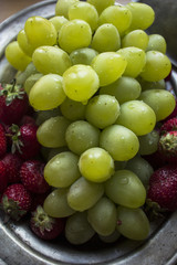 photo of fresh, green, ripe grapes and fragrant strawberries