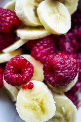 close-up of porridge with raspberries and banana in a plate