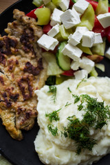 hot mashed potatoes with herbs, salad and meat