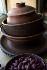clay, brown dishes on a wooden table