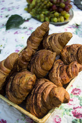 Wicker basket with fresh and tasty croissants