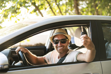 Men sitting in a rental car on holiday vacancy