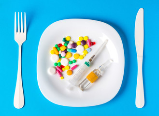 Pills plate concept of  antibiotic  food vitamins in capsules and tablets. nutritional supplements
