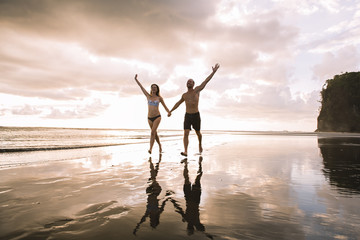 Fototapeta premium Couple in love having romantic tender moments at sunset on the beach
