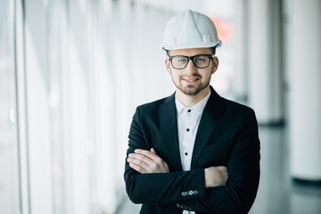 Handsome young technician in control room post arms crossed. Concept Engineer technician