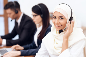 An Arab woman works in a call center.