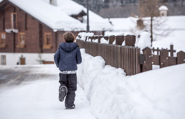 Little boy playing in the snow
