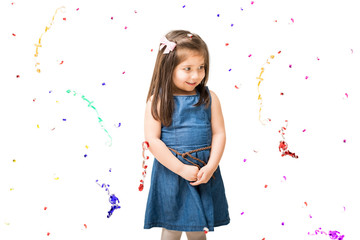 Cute little girl with confetti falling around