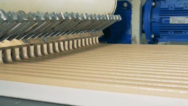 Dynamic footage of candy cream flowing out of factory machine in lines