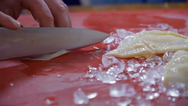 Chef cuts raw squid
