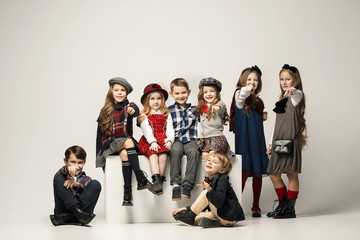 Fototapeta premium The group of beautiful girls and boys on a pastel background