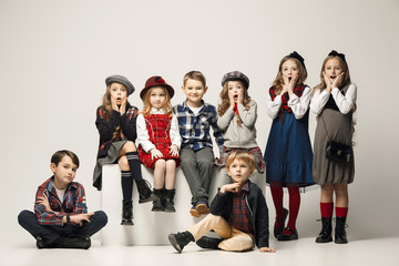 Fototapeta premium The group of beautiful girls and boys on a pastel background