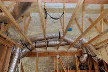 Insulation of attic with fiberglass cold barrier and insulation material