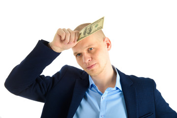 Thoughtful businessman in suit on white background holding cash. Thinking about making money.