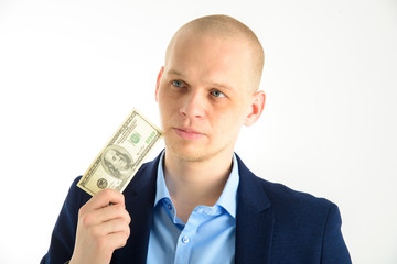 Thoughtful businessman in suit on white background holding cash. Thinking about making money.