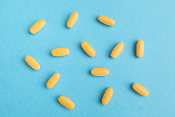 yellow pills on blue background