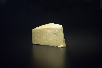 piece of cheese on black background