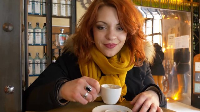 Beautiful woman drinking espresso- indoor