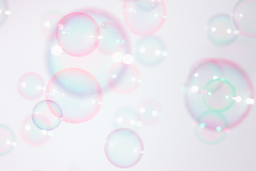 Beautiful pink soap bubbles float in the air.