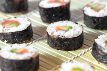Sushi rolls on bamboo mat. Concept design. Japanese cuisine.
