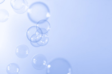 Abstract blue soap bubbles float in the air