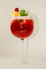 red alcoholic drink with ice on white background