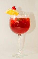 red alcoholic drink with ice on white background
