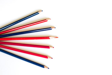 a few colored pencils scattered on a white