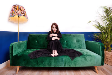 Girl on a green sofa.