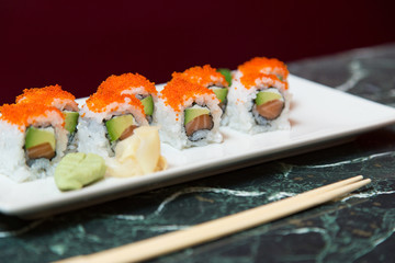 Tray of maki sushi with avocado, salmon and caviar