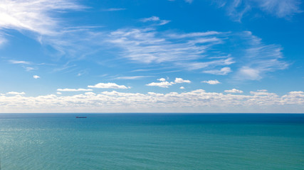 Lonely boat on the sea. A ship on the background of the sea and thick clouds.