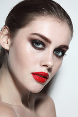 Young beautiful woman with red lipstick and smoky eye make-up