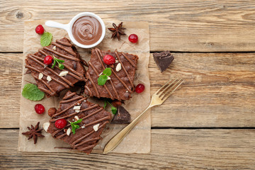 Chocolate brownie cake, dessert with nuts on wooden background.top view