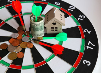 Target Success,saving concepts with house , dolar and coins on the dart . Real estate and mortgage
