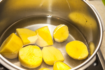 The little girl peeling and cutting potatoes