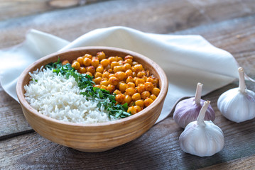 Bowl of chickpea curry with white rice and fresh cilantro