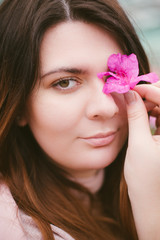 Beautiful girl in the greenhouse of the botanical garden among the azaleas