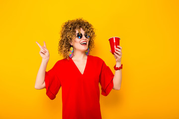 Attractive woman with short curly hair and drink