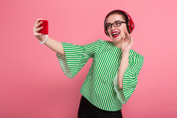 Businesswoman with phone and earphones