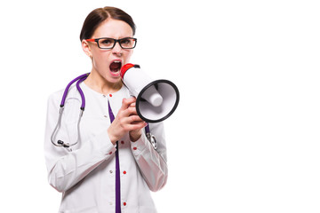 Young beautiful female doctor holding tablet in her hands speak in megaphone on white background