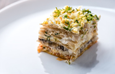 Fish pie with a dough, egg and fresh herbs